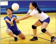  ?? Photo by Mike Eckels ?? Decatur’s Shaney Lee (left) and Mailee Xiong intercept the ball during the Decatur-Elkins match at Peterson Gym in Decatur on Sept. 20.