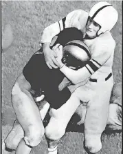  ?? [OKLAHOMAN ARCHIVES] ?? OU’s Joe Golding, right, pulls down Army’s John Stanley during the 1946 game at West Point.