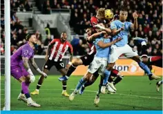  ?? ?? 365+65! )YLU[MVYK»Z +\[JO NVHSRLLWLY 4HYR -SLRRLU ^H[JOLZ HZ OPZ [LHTmates defend from Manchester City’s Dutch defender #06 Nathan Ake during the ,UNSPZO 7YLTPLY 3LHN\L MVV[IHSS TH[JO IL[^LLU )YLU[MVYK HUK 4HUJOLZ[LY *P[` H[ the Gtech Community Stadium in London. — AFP