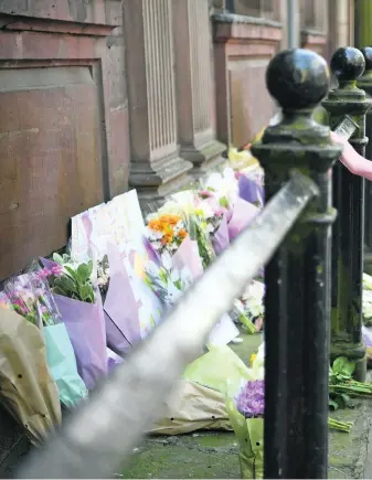  ?? Jeff J Mitchell / Getty Images ?? People leave tributes in St Ann’s Square to the victims of terror attack. At least 22 people were killed in a suicide bombing at a pop concert in Manchester.