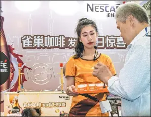  ?? PROVIDED TO CHINA DAILY ?? A man tries a Nestle coffee product at the 19th Cross-Straits Fair for Economy and Trade in Fuzhou, capital of East China’s Fujian province, on May 18, 2017.