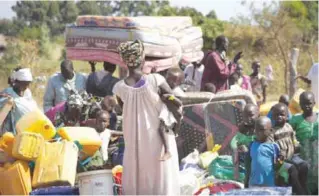  ??  ?? KOBOKO, Uganda: In this Jan 6 2014 file photo, refugees who fled the recent violence in South Sudan and crossed the border into Uganda arrive and await transporta­tion from a transit center in this town. — AP