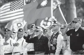  ??  ?? VETERANS join the color guard during Saturday’s ceremony at the cemetery, which opened in 1889 and has buried nearly 88,000 veterans and family members.