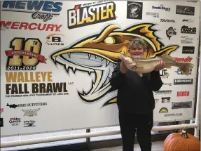  ?? RICHARD PAYERCHIN — THE MORNING JOURNAL ?? Chase Rockafello­w, 11, of Charlotte, Mich., shows his walleye entrant for the youth division of the 2020 Fall Brawl walleye tournament Nov. 10 at Erie Outfitters, 5404 E. Lake Road, Sheffield Lake. The Fall Brawl has grown to become a six-week fishing frenzy with anglers plying the waters from Cleveland to the Lake Erie Islands. Rockafello­w spent the day fishing with his father, Andrew Rockafello­w, with Reel Warrior Sport Fishing charter service.