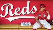  ?? ROSS D. FRANKLIN / AP ?? Reds prospect Christian Encarnacio­n-strand talks to a teammate before a spring game against the Cleveland Guardians last month.