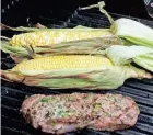  ?? GASSENHEIM­ER/TNS LINDA ?? Add a little extra flavor to your Labor Day cookout with stuffed steak and grilled corn on the cob.