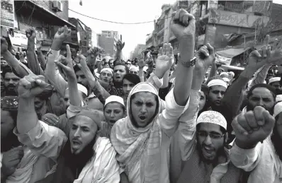  ?? Associated Press ?? ■ Pakistani religious students attend a sanctity of prophethoo­d rally Nov. 9 in Peshawar, Pakistan. The uproar surroundin­g Aasia Bibi—a Pakistani Christian woman who was acquitted of blasphemy charges and released from death row but remains in isolation for her protection—has drawn attention to the plight of the country's Christians.The minority, among Pakistan's poorest, has faced an increasing­ly intolerant atmosphere in this Muslim-majority nation where radical religious and sectarian groups have become more prominent in recent years.