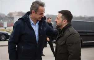  ?? (Ukrainian Presidenti­al Press Service/Handout via Reuters) ?? UKRAINE’S PRESIDENT Volodymyr Zelensky welcomes Greek Prime Minister Kyriakos Mitsotakis at the port of Odesa on Wednesday.