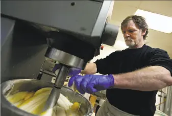  ?? Brennan Linsley / Associated Press 2014 ?? Masterpiec­e Cakeshop owner Jack Phillips cracks eggs into a cake batter mixer in 2014 inside his store in Lakewood, Colo. He had refused to create a wedding cake for a same-sex couple.