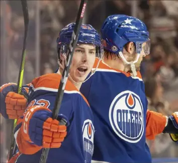  ?? Amber Bracken/Associated Press ?? Ryan Nugent-Hopkins, left, and Leon Draisaitl celebrate a goal in the second period Saturday. The Oilers defeated Nashville, 4-1, in Edmonton, Alberta, for their 16th consecutiv­e win.