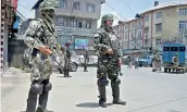  ?? — PTI ?? Security personnel stand guard during curfew in Srinagar on Sunday. Authoritie­s imposed curfew in parts of the Valley following the killing of top Hizbul militant commander Sabzar Ahmad Bhat on Saturday.