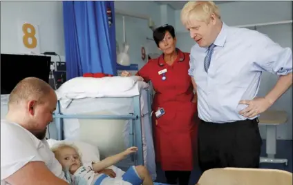  ??  ?? Britain’s Prime Minister Boris Johnson meets patients and families Cornwall Hospital in Truro, southwest England, on Monday. PETER NICHOLLS/POOL VIA AP