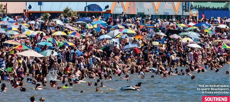  ??  ?? Not an inch of space to spare: Beachgoers in Essex yesterday