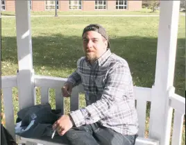  ?? STAFF PHOTO BY JACQUI ATKIELSKI ?? Michael Mueller, college student, sits in the gazebo where smoking is currently permitted at the College of Southern Maryland, Leonardtow­n campus. The college plans to ban smoking on all of its campuses starting in 2017.