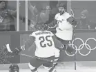  ?? PATRICK SEMANSKY/AP ?? Vladislav Gavrikov celebrates with Mikhail Grigorenko after scoring a goal for Russia in the 2018 Winter Olympics. The two are now teammates with the Blue Jackets.