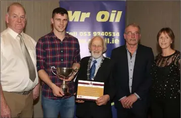  ??  ?? Athlete of the year Michael Bowler (second left) with Seamus Darcy (Mr Oil), Nicky Cowman (President, Athletics Wexford), Paddy Morgan (Chairman, Athletics Wexford), and Marie Mooney (Mr Oil).