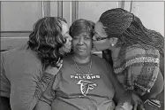  ?? William Burrough via AP ?? In this Feb. 1, 2017, photo provided by the Burrough Family, Bessie Burden (center) gets kisses from her daughters Theresa Burrough (left) and Lashieka Mitchell in Colquitt. Burden died Oct. 22, 2020, after becoming infected with the coronaviru­s during an outbreak at the nursing home.