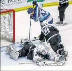  ?? GARY MANNING ?? Cole Mclaren sprawls on the ice as he tries to defend the Valley net with the help of Drew Packman. Edmundston had some good chances but wasn’t able to slip one past Mclaren.