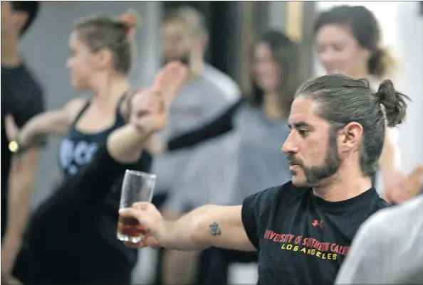  ?? PHOTOS: TONY DEJAK/THE ASSOCIATED PRESS ?? Craft breweries are partnering up with yoga studios, above, in an attempt to get more men to try yoga. Lauren Kaluza, centre left, practises yoga at the Platform Beer in Cleveland.