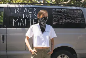  ?? Sarahbeth Maney / The Chronicle ?? Tessa Maria, 20, of Martinez painted her van to memorializ­e Black people who have been killed by police officers. She says the vandalism of the Black Lives Matter mural by a white couple has exposed the hidden racism in East Bay communitie­s. Black Lives Matter groups descended on the town to demonstrat­e Sunday.