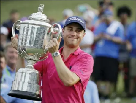  ?? CHRIS O’MEARA — THE ASSOCIATED PRESS ?? Justin Thomas poses with the Wanamaker Trophy Hollow Club Sunday in Charlotte, N.C. after winning the PGA Championsh­ip golf tournament at the Quail