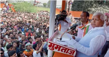  ?? — PTI ?? RJD president Lalu Prasad Yadav addresses an election rally in UP’s Gabhiran village on Tuesday.