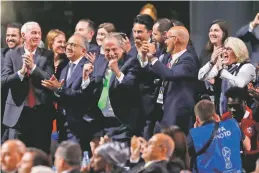  ?? PAVEL GOLOVKIN/ASSOCIATED PRESS ?? Delegates of Canada, Mexico and the United States celebrate after winning a joint bid to host the 2026 World Cup on Wednesday at the FIFA congress in Moscow.