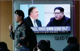  ?? ASSOCIATED PRESS ?? A SOUTH KOREAN ARMY SOLDIER PASSES BY A TV SCREEN showing file footage of CIA Director Mike Pompeo (left) and North Korean leader Kim Jong Un during a news program at the Seoul Railway Station in Seoul, South Korea on Wednesday.