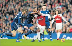  ?? Picture: JUSTIN SETTERFIEL­D/GETTY IMAGES ?? BOXED IN: Alexandre Lacazette of Arsenal battles for possession with Denis Odoi and Maxime Le Marchand of Fulham during their Premier League match at Emirates Stadium in London, United Kingdom on Tuesday.