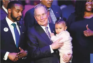  ?? AP ?? Democratic presidenti­al candidate and former New York City Mayor Michael Bloomberg is joined on stage by supporters during his campaign launch of “Mike for Black America,” at the Buffalo Soldiers National Museum, on Thursday.