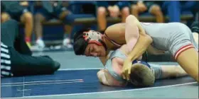  ??  ?? Owen J. Roberts’ David Forrest works to turn over Pottstown’s Damien Saltsman during their match at 106. Forrest won by pin in 36 seconds to close out the match.