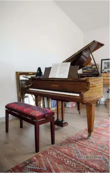  ??  ?? Clockwise from top left: The wall hanging is a rug that Wilma’s mother made from small pieces of material sewn together; a corner of the music room acts as a sewing station; Wilma’s beautiful piano.