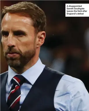  ??  ?? A disappoint­ed Gareth Southgate leaves the field after England’s defeat