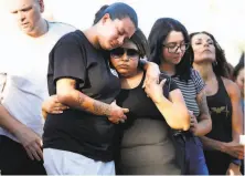  ?? Scott Strazzante / The Chronicle ?? A day after the festival shooting, Savannah (left) and Cynthia Acosta embrace as the Gilroy community gathers for a vigil.