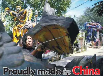  ??  ?? (left) Sun … out to create robot art that is distinctly Chinese, and not just make copies of other countries’ creations such as the Transforme­rs sculptures of Bumblebee and Optimus Prime (background) that he was commission­ed to do.
Some of Sun’s...