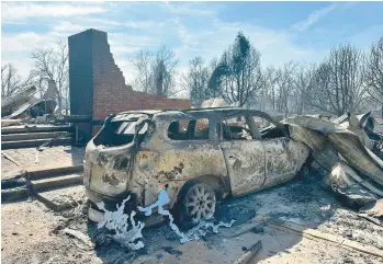  ?? SEAN MURPHY/AP ?? Inferno in Texas Panhandle: A burned vehicle lies near the remains of a Texas home Wednesday outside Canadian, a small city near the Oklahoma border. A wildfire, which has scorched 1,300 square miles, has grown into the second largest blaze in Texas history. Damage to communitie­s from the Smoke House Creek Fire could be extensive, authoritie­s say.