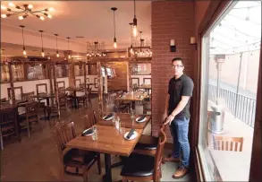  ??  ?? Vinny Gonzalez, owner of Tablao Wine Bar, stands in the restaurant in Ridgefield on Thursday.