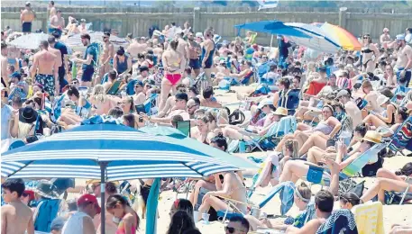  ?? JiM MichauD photos / Boston heralD file ?? FUN IN THE SUN: Beach activities, such as on this sunny May day at Carson Beach in South Boston, will get a boost this year, as Save the Harbor/Save the Bay and the Department of Conservati­on and Recreation are teaming up to sponsor fun activities in numerous beachside towns.