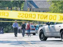  ?? LLOYD FOX/BALTIMORE SUN ?? Police tape blocks off the intersecti­on near the shooting.