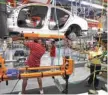  ?? — Reuters ?? General Motors’ workers assemble a car on the assembly line at the GM Lansing Grand River Assembly Plant in Michigan.