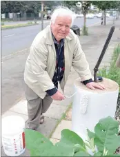  ??  ?? OVERJOYED: Werner Kirchhoff paints a beacon that he rediscover­ed along Oxford Road. The beacon has been there for over a century. Kirchhoff last saw the beacon when he was a youngster.