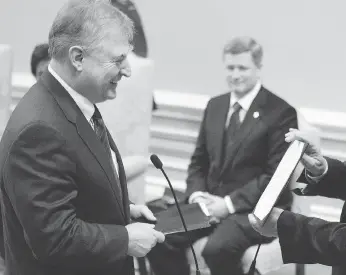  ??  ?? Prime minister Stephen Harper watches as David Emerson is sworn in to the Conservati­ve cabinet, after Emerson’s dramatic floor-crossing from the Liberals just weeks after the 2006 election.