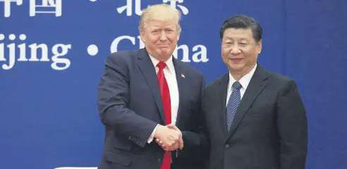  ??  ?? U.S. President Trump (L) and China’s President Xi shake hands during a business leaders event at the Great Hall of the People in Beijing, Nov. 9, 2017.