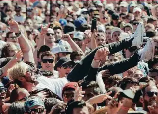  ??  ?? A crowd surfer wearing Vans at the Vans Warped Tour in San Diego, California in June.