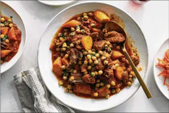  ?? DAVID MALOSH PHOTOS/THE NEW YORK TIMES ?? Lamb shanks with apricots and chickpeas in New York on Oct. 22 Braised shanks, a carrot salad and a molasses ginger cake: This cozy menu from David Tanis, drawing from North Africa, is sure to warm. Food styled by Simon Andrews.