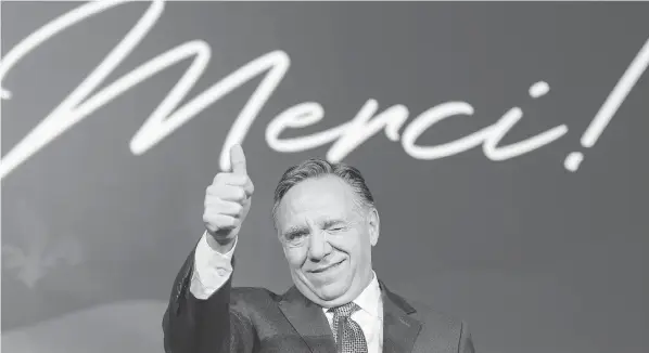  ?? RYAN REMIORZ / THE CANADIAN PRESS ?? Coalition Avenir Québec leader François Legault with a wink and a thumbs-up as he speaks to supporters Monday night in Quebec City after winning the election.