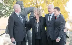  ?? LIAM RICHARDS/THE CANADIAN PRESS ?? Marty Howe, left, son of Gordie Howe, his sister Cathy Howe, and brothers Mark and Murray hug following the interment Sunday of Gordie and Colleen Howe’s ashes in Saskatoon.