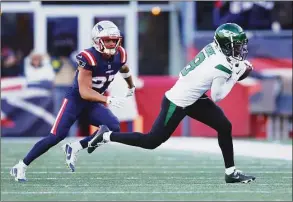  ?? Adam Glanzman / Getty Images ?? Elijah Moore (8) of the New York Jets catches a pass during the second quarter against the New England Patriots at Gillette Stadium on Sunday in Foxborough, Mass.