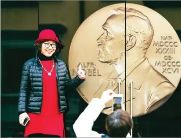  ?? AFP ?? A woman poses for a picture at the entrance of the Alfred Nobel Museum in Stockholm, Sweden.