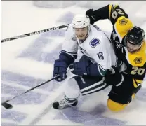  ?? BRUCE BENNETT/ GETTY IMAGES ?? Chris Tanev ( left) is getting another shot with the Canucks after the team developed problems moving the puck out of its own end when Sami Salo was injured.